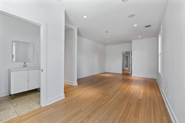 spare room featuring light hardwood / wood-style floors and sink