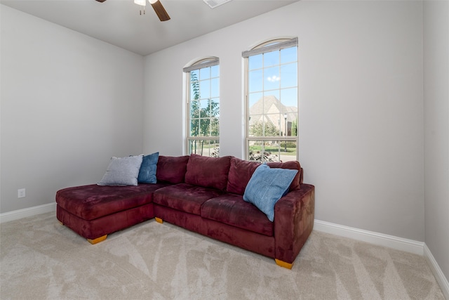 carpeted living room featuring ceiling fan