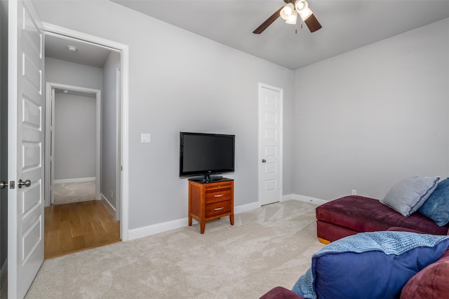 living room with ceiling fan and light carpet