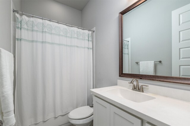 full bathroom featuring toilet, vanity, and shower / bathtub combination with curtain