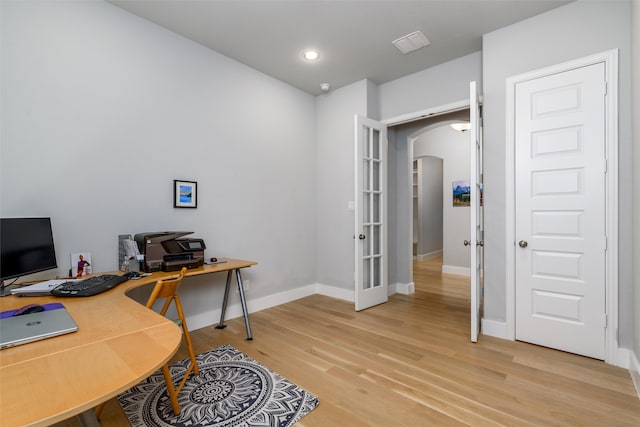 office featuring hardwood / wood-style flooring and french doors