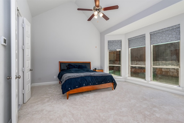 carpeted bedroom featuring high vaulted ceiling and ceiling fan