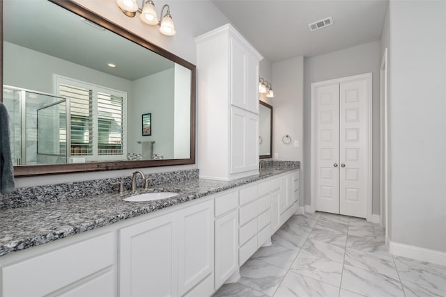 bathroom with an enclosed shower and vanity