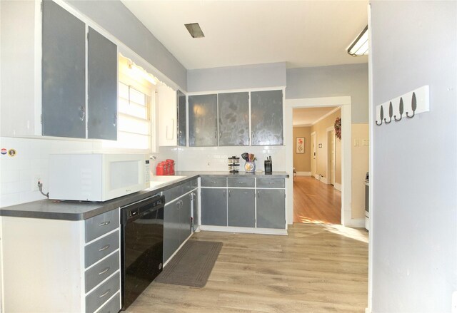 kitchen with dishwasher, gray cabinets, light hardwood / wood-style floors, and decorative backsplash