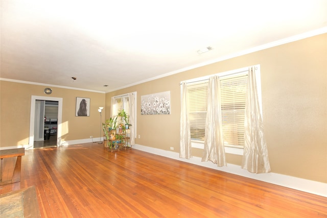 spare room with wood-type flooring and ornamental molding