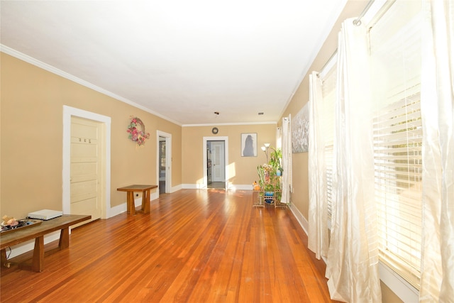 corridor with hardwood / wood-style flooring and ornamental molding