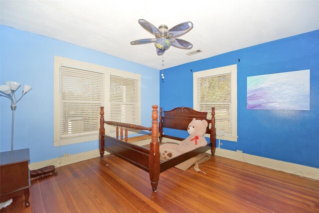 bedroom featuring ceiling fan and dark hardwood / wood-style floors