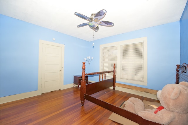 bedroom with ceiling fan and dark hardwood / wood-style floors