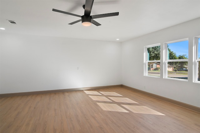 unfurnished room with light wood-type flooring and ceiling fan