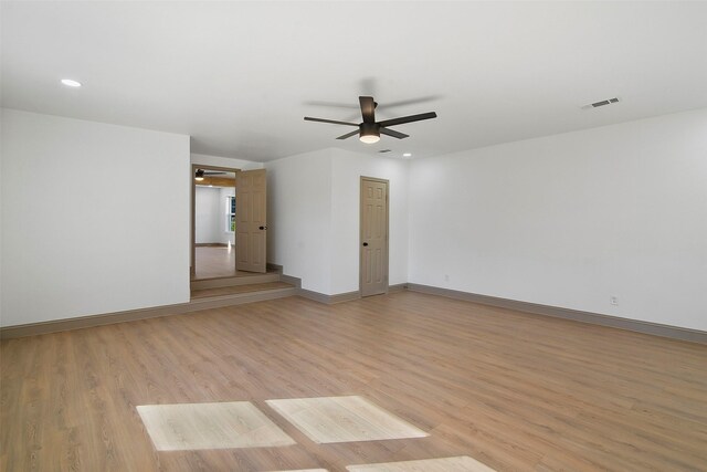 empty room featuring ceiling fan and light hardwood / wood-style floors