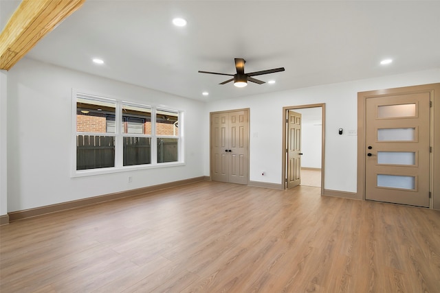 unfurnished living room featuring light hardwood / wood-style floors and ceiling fan