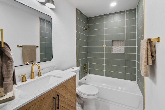 full bathroom with vanity, tiled shower / bath combo, and toilet