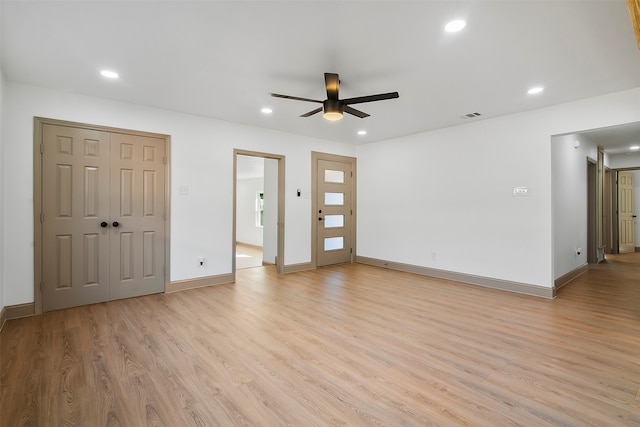 unfurnished living room with light wood-type flooring and ceiling fan