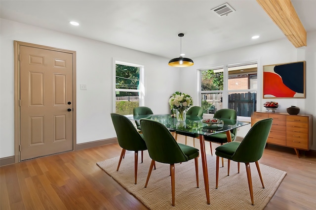 dining room with a wealth of natural light and light hardwood / wood-style flooring