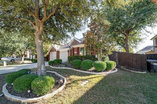 view of front of property with a garage and a front yard