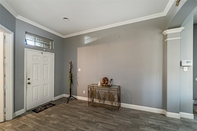 entrance foyer with decorative columns, dark hardwood / wood-style flooring, and ornamental molding