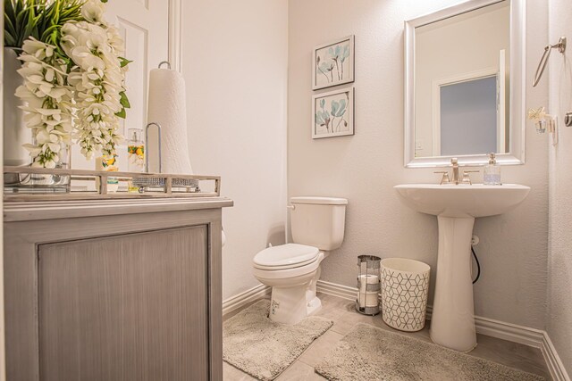 bathroom featuring tile patterned floors and toilet