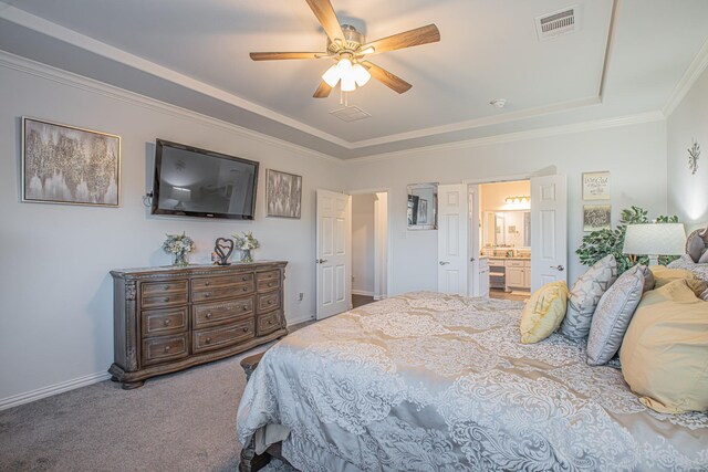 carpeted bedroom with connected bathroom, ceiling fan, and crown molding