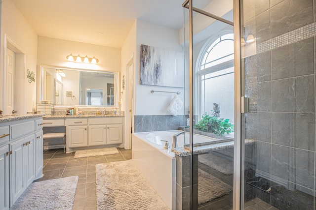 bathroom with vanity and independent shower and bath