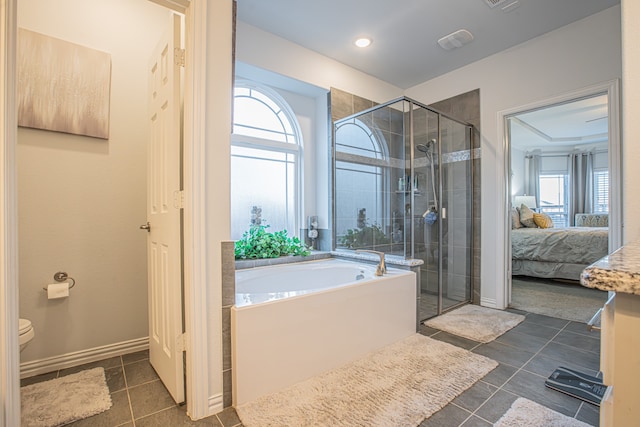 bathroom featuring tile patterned flooring, plus walk in shower, and toilet