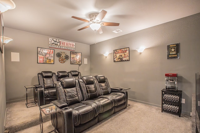 carpeted home theater featuring ceiling fan