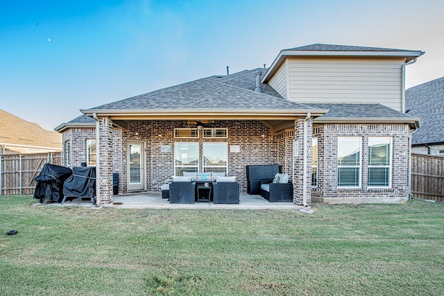 back of house featuring outdoor lounge area, a patio, ceiling fan, and a lawn