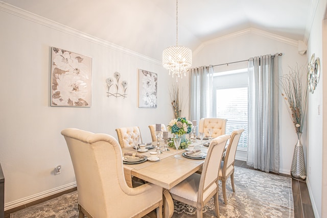 dining room featuring hardwood / wood-style floors, an inviting chandelier, vaulted ceiling, and crown molding