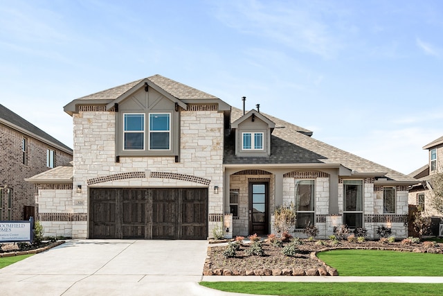 view of front facade with a garage and a front lawn