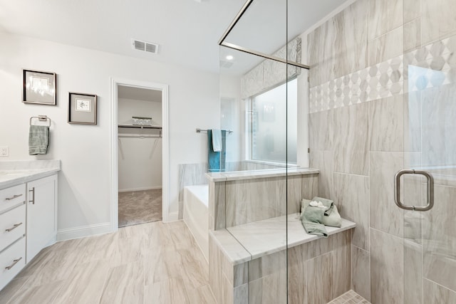 bathroom with vanity and separate shower and tub