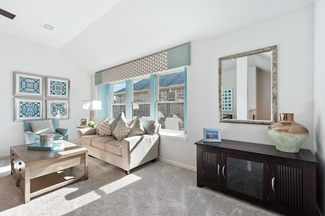 carpeted living room featuring vaulted ceiling