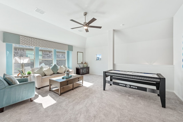 interior space featuring lofted ceiling, light carpet, and ceiling fan