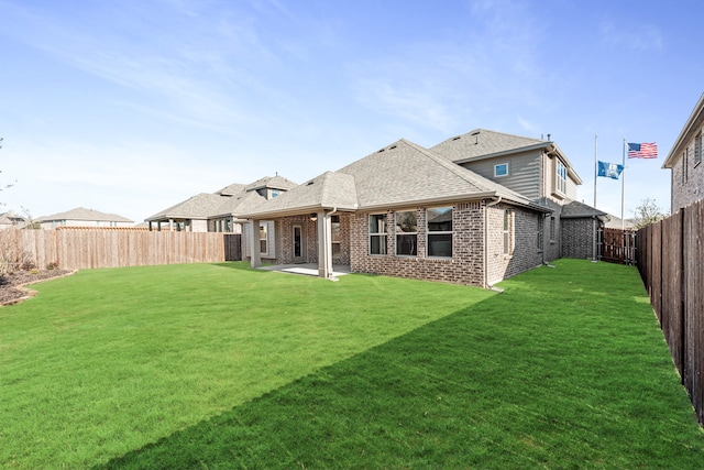 rear view of property with a patio and a yard