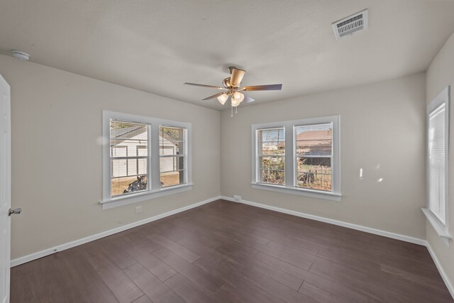 empty room featuring dark wood-type flooring and ceiling fan