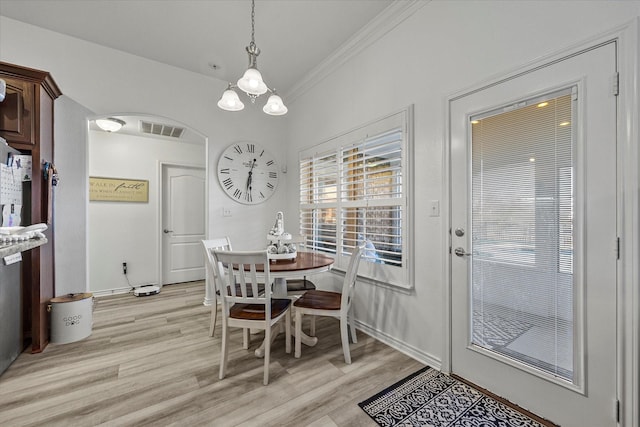 dining room featuring ornamental molding and light wood-type flooring