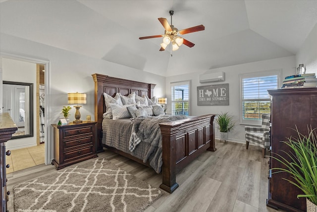 bedroom with ceiling fan, lofted ceiling, a wall unit AC, and light wood-type flooring