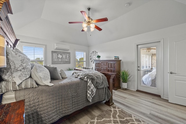 bedroom with vaulted ceiling, a wall unit AC, light hardwood / wood-style floors, and ceiling fan