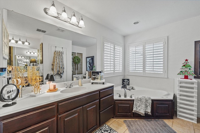 bathroom featuring vanity, tile patterned floors, and a bathtub