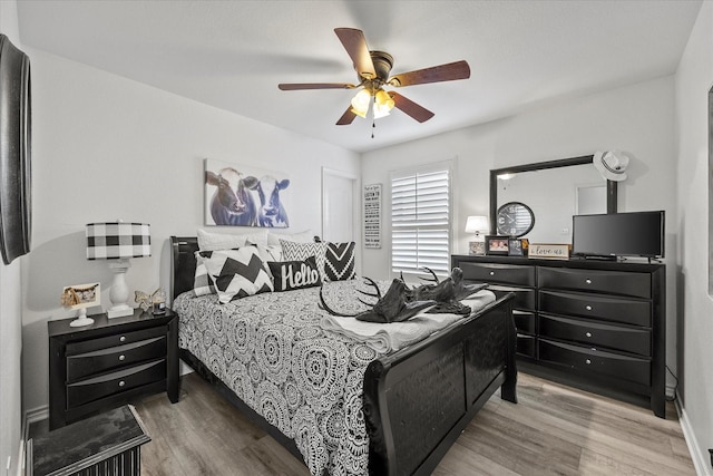 bedroom with hardwood / wood-style flooring and ceiling fan