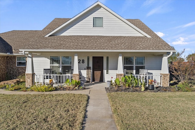 craftsman inspired home with a porch and a front yard