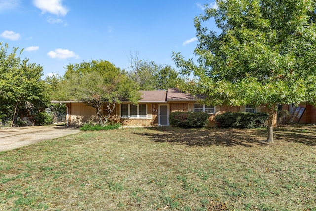 ranch-style house with a front yard and a carport