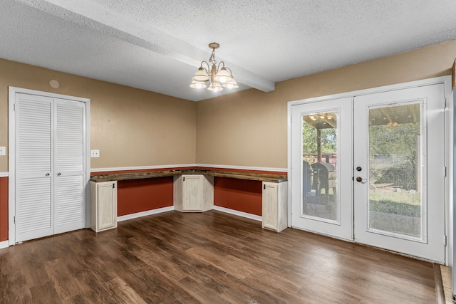 interior space with french doors, built in desk, and dark hardwood / wood-style floors