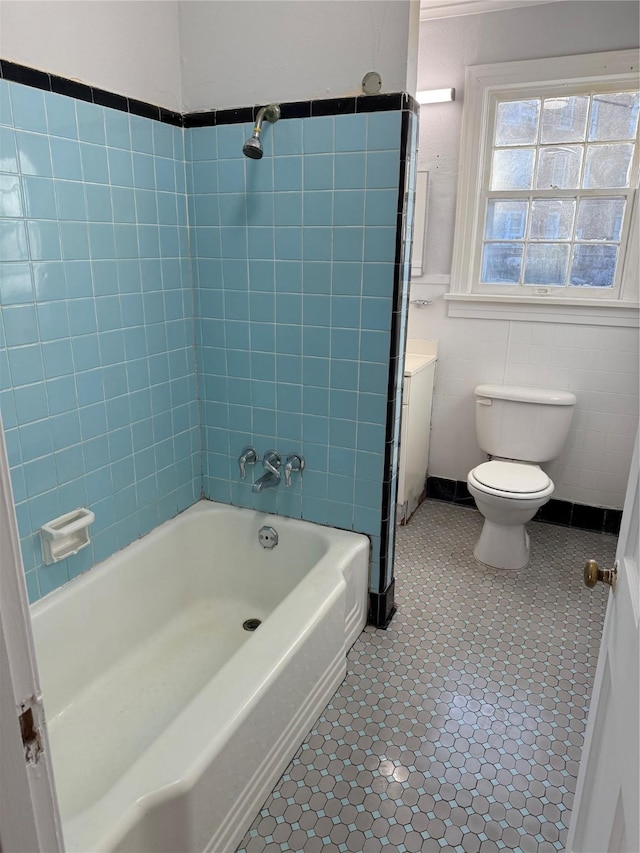 full bathroom featuring tile patterned flooring, vanity, shower / bathtub combination, and toilet