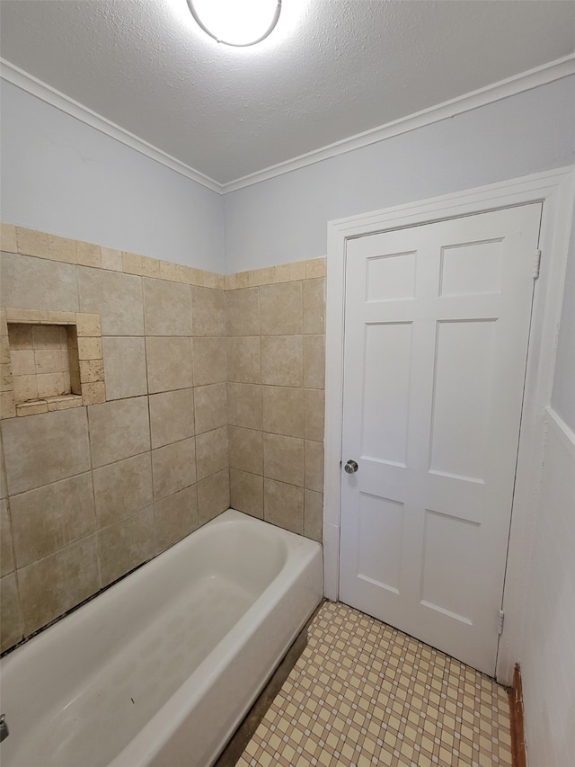 bathroom with ornamental molding and a textured ceiling