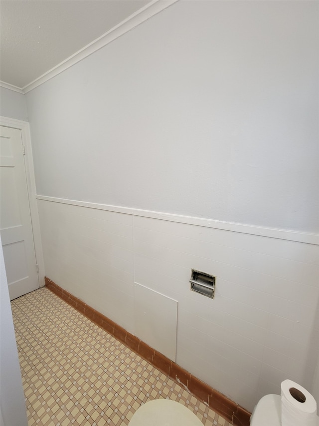 bathroom with toilet and ornamental molding