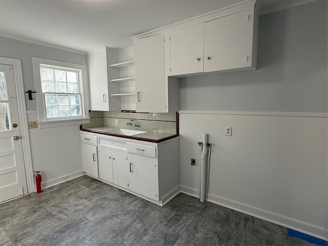 kitchen featuring white cabinetry and sink