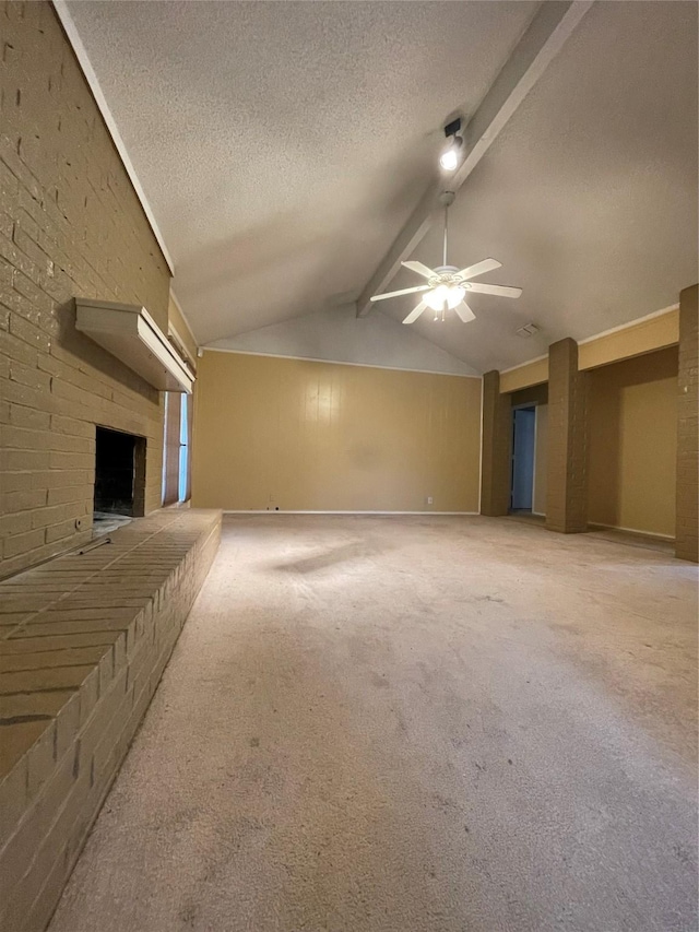 unfurnished living room featuring carpet flooring, a textured ceiling, lofted ceiling with beams, and ceiling fan