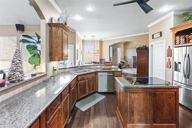 kitchen featuring sink, stainless steel appliances, dark wood-type flooring, light stone counters, and crown molding