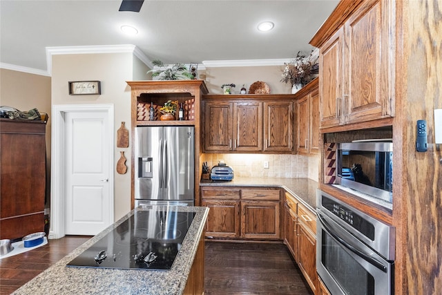 kitchen with light stone countertops, dark wood-type flooring, stainless steel appliances, tasteful backsplash, and ornamental molding