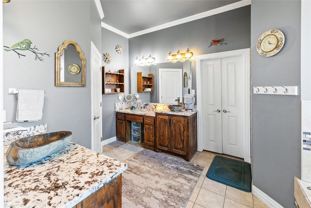 bathroom featuring vanity, tile patterned floors, and crown molding