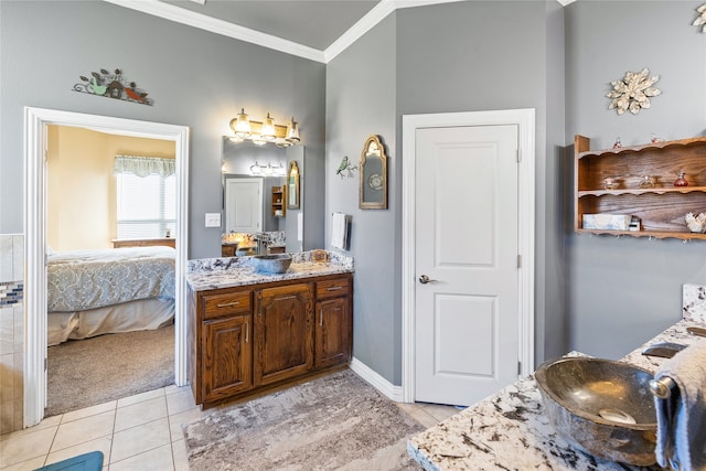 bathroom with tile patterned floors, vanity, and ornamental molding